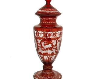 4296
A Bohemian Cut-Glass Lidded Vase
Late 19th/early 20th century
The art glass vase intaglio cut from ruby to clear with floral motifs centering a stag and a castle
15" H x 15" Dia.
Estimate: $300 - $500
