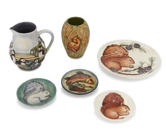 4300
A Group Of Moorcroft Pottery
Circa 1980s-90s; Burslem, England
Each with Moorcroft backstamp, with further various dates and markings
Each glazed ceramic with animal motifs, comprising a squirrel plate, a puffin pitcher, a vase with wheat and a field mouse, two small plates with squirrels, and one small plate with a fish, 6 pieces
Largest: 0.5" H x 8.75" Dia.
Estimate: $300 - $500