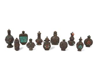 4326
A Group Of Tibetan Silver And Semiprecious Snuff Bottles
19th century
Comprising of various shapes and sizes, each with a silver body decorated with turquoise, coral, and enamel cabochons, 11 pieces
Largest: 4.5" H x 2" W; smallest: 2.75" H x 1.875" W
Estimate: $400 - $600