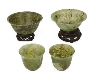 4333
A Group Of Chinese Jade Items
20th century
Paper box for cups reads: Kwangtung Arts and Crafts / Made in China
Comprising of a pair of bowls, each with associated carved wood stands, and a pair of cups in fitted paper box case, 4 pieces
Larger pair: 2.625" H x 3.75" Dia.; smaller: 1.875" H x 2.25" Dia.
Estimate: $400 - $600