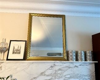 Large gold framed mirror.