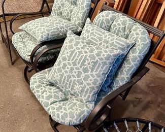 Metal yard chairs with cushions.