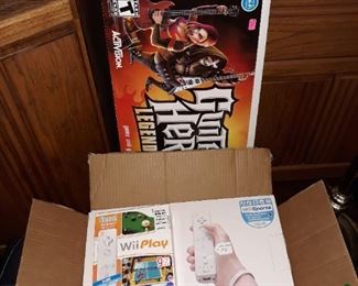 Wii game console with accessories, as well as, Guitar Hero set.