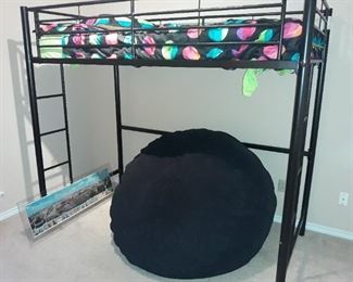 Bunk bed designed for a desk to go below and large bean bag.