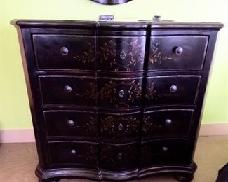 Dark wood with a floral pattern on the dresser