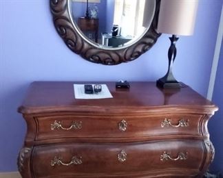 Solid dark wood dresser 
Decorative mirror
Lamp