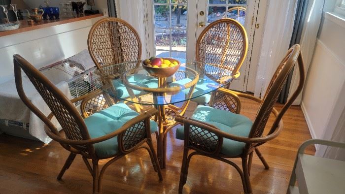  Peacock rattan arm chairs w/pedestal glass top table.  C. 1970.