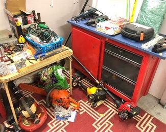 Work bench, trimmer, chain saw, blower, and misc tools 