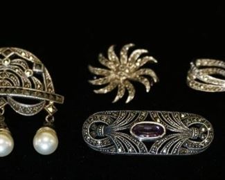 1009	GROUP OF FOUR STERLING SILVER & MARCASITE BROOCH PINES, INCLUDES ONE W/ GENUINE AMETHYST, & ONE WITH DANGLING IMITATION PEARLS. TOTAL WEIGHT COMBINED INCLUDING STONES 1.071 TROY OUNCES.
