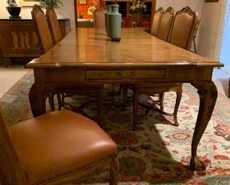 Chippendale bleached mahogany dining table with 2 leaves and 8 French chairs in high quality brown leather  with Greenbaum’s tags