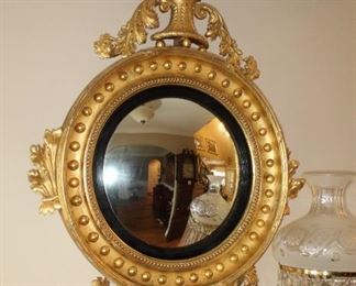 Presell @ $9998
Federal Giltwood Convex Mirror. Topped with an eagle holding a ball and chain at the crest, The circular frame is adorned with gilt spheres with a base of acorn and foliate ornament matching that of the crest. Circa 1820
Dimensions: 52”H x 32”W
Stock #016