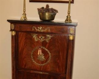 Presell @ $7998
Secrétaire Abattant, burled walnut with black overhanging marble top over deep panel with draped ormolu mounts, over two full pilasters with bronze capitals, Desk section and drawers flanked by a pair of pilasters. Lift down door heavily decorated with ormolu. The interior is fitted with drawers and cubby holes. The writing surface is original black leather. Circa 1820
Dimensions: 56”H x 38”W x 18”D
Stock #023