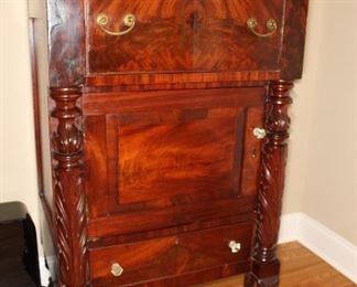 Presell @ $4498
American Empire Mahogany Silver Chest. Overhanging top with one deep drawer over cabinet door and one drawer. Unique form with acanthus carved pilasters and paw feet. Bale pulls on top and glass pulls on base. Circa 1840
Dimensions 17”H x 20”W
Stock #024