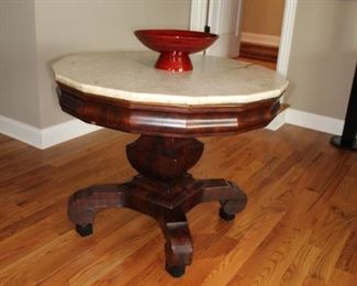 Presell @ $8998
American Empire mahogany center table with original white marble top, unique sixteen-sided marble with conforming base with vase form pedestal and c-scroll feet. Circa 1835
Dimensions: 35”H x 42”W x 18”D
Stock #034