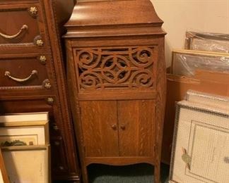 $800     Vintage Silvertone Phonograph DG145-18     Description:  Antique Sears and Roebuck Silvertone Phonograph.   Features a nice cut geometric medallion over the speaker and lower storage below.
Sears and Roebuck began using the Silvertone name in early 1916. First, for its line of phonographs, then radios, musical instruments, televisions... ultimately applying it to nearly any entertainment or electronic related item right on into the early 1970s
Condition:  Light wear commensurate with age.  Cloth in front of speaker needs to be replaced.  In working condition                                            https://goodbyhello.com/products/vintage-silvertone-phonograph-dg145-18?_pos=1&_sid=393e46d62&_ss=r