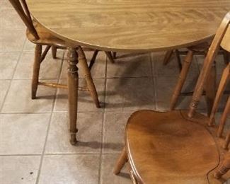 Vintage Ethan Allen oval table and 4 chairs in Nutmeg. Some vintage wear, but in good condition. Table has extra leaf ( shown in picture). It can be removed to form a small round breakfast table. With the leaf the table measures 52 1/4" long. Without the leaf the diameter is 42 1/2". $125