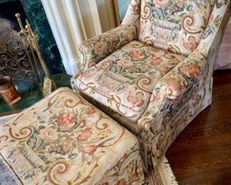 Custom-upholstered floral armchair and rolling ottoman. 