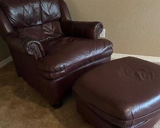 Cordovan leather club chair and ottoman, with nail head trim