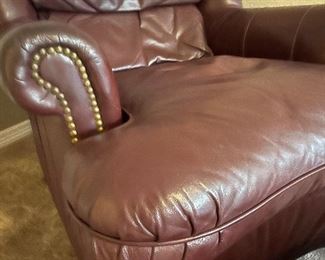 Burgandy leather club chair and ottoman, with nail head trim