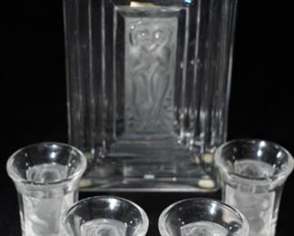 Set of 4 Lalique cherub & nudes shot glasses.  Interestingly, the shot glasses match the perfume bottle.
