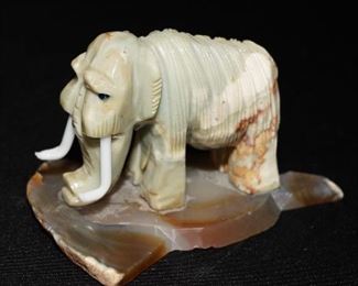 Carved marble elephant on polished agate