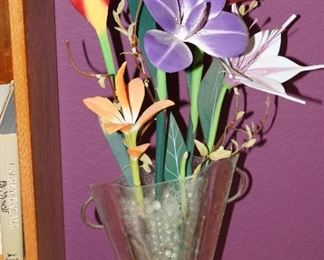 Triangular glass vase with carved wood flowers.