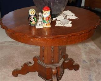 Scalloped edge carved wood pedestal table