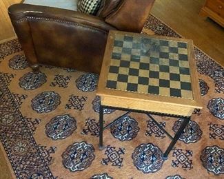 Leather recliner, chess table, cool rug.