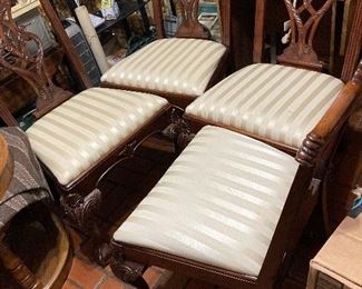 Four matching hand chairs with white upholstery and ball in claw feet