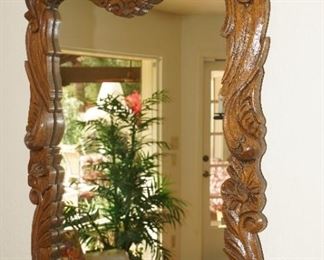 Ornate hand carved dark wood mirror 
