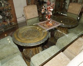 Glass topped Schnadic dining table sits atop these fantastic carved wood pedestal bases