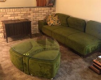 2 Mid-century modern couches with matching coffee table that has 3 rolling stools that tuck under the table