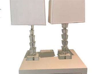 $115 USD     Pair Modern Stacked Clear Crystal Cubes Table Lamps ST100-116     Description:  Add sparkle to any room with this contemporary crystal glass table lamp. The body features stacked cubes of clear crystal accented by chrome finish elements. This appealing design is topped with a white fabric drum shade.  Expertly arranged crystal glass accents allow this contemporary table lamp to provide stunning accent lighting.   Stacked Clear Crystal Glass Cubes White Fabric Tapered Rectangle Shade Decor for Living Room Bedroom House Bedside Nightstand Home Office
Condition: Excellent Condition.  
Dimensions: 25.5"H
Local Pick up Vienna VA.  Contact us for shipper suggestions     https://goodbyhello.com/products/pair-modern-stacked-clear-crystal-cubes-table-lamps-st100-116?_pos=5&_sid=5c75edaa7&_ss=r