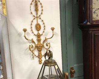 One of a pair of wall sconces, and in foreground, a non functional binnacle which lights
