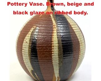 Lot 77 Bulbous Narrow Neck Art Pottery Vase. Brown, beige and black glaze on ribbed body. 