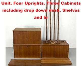 Lot 239 Danish Modern Teak Wall Unit. Four Uprights. Three Cabinets including drop down desk. Shelves and br