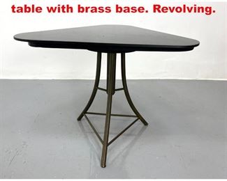 Lot 268 Black glass top triangle table with brass base. Revolving. 