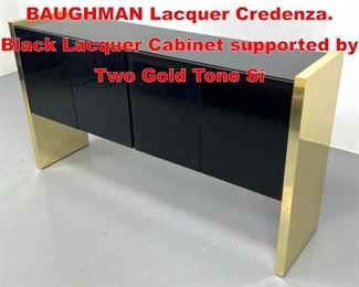 Lot 324 THAYER COGGIN by MILO BAUGHMAN Lacquer Credenza. Black Lacquer Cabinet supported by Two Gold Tone Si