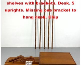 Lot 459 HG TEAK wall unit. 5 shelves with brackets. Desk. 5 uprights. Missing one bracket to hang desk. Chip