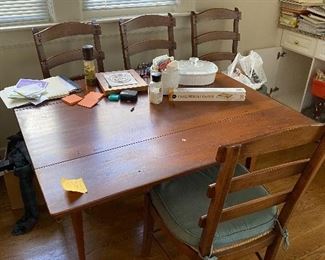 Drop leaf table with sturdy chairs.