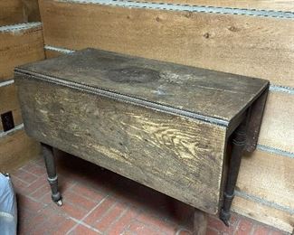 Primitive drop leaf table on casters