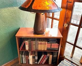 One of 3 Willitt MCM Cherry dovetailed bookcases filled with books and a Fantastic large Michael Ashford hand hammered copper bullet lamp with Micah shade.