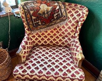 Lovely upholstered chair, and small rug.