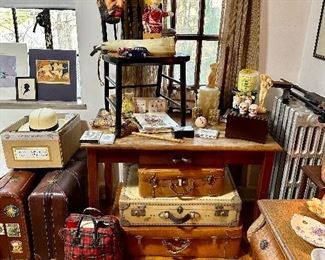Vintage wood table with boobies handle, vintage suitcases and oddities.