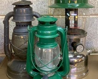 Vintage lanterns: black Dietz Little Wizard oil lantern; green battery operated lantern; green and glass large Coleman lantern