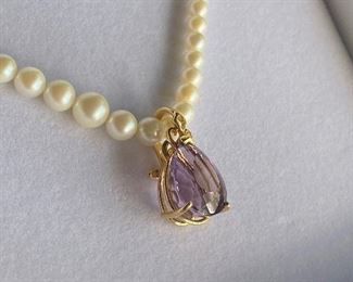 Donation by Antiquarian Traders - 7ct pear shaped Amethyst on pearl enhancer, bail allows to wear on omega chain or regular chain. 