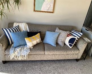Upholstered couch by Max Home; numerous fun/stylish throw pillows.