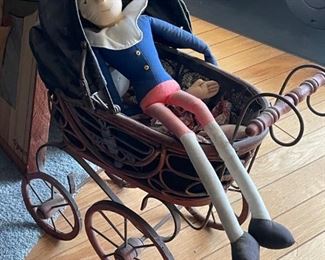 Miniature toy stroller and dolls.