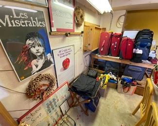 Posters and luggage. Dining room table set and chairs.