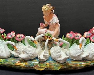 Vintage Mollica Planter - the details on this are simply lovely! Features a beautiful young girl perched among flowers with swans. Exquisite fine details in the modeling of the figurines and gives them a graceful quality as do the delicately hand painted features of the faces and the floral print of the girl's dress.
Measures 21" x 8" x 12". Signed on the back. A small very slight incidental hairline crack on the back which cannot be seen from the front of the planter.
